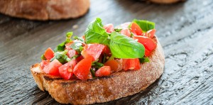 Italian Bruschetta With Chopped Vegetables, Herbs And Oil On Gri
